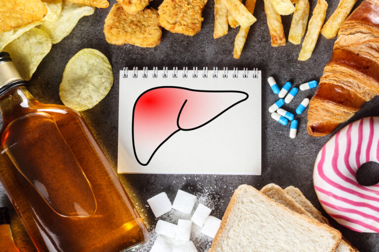 Liver drawn on a block with various harmful substances for the liver such as alcohol, sugar, potato chips and medication